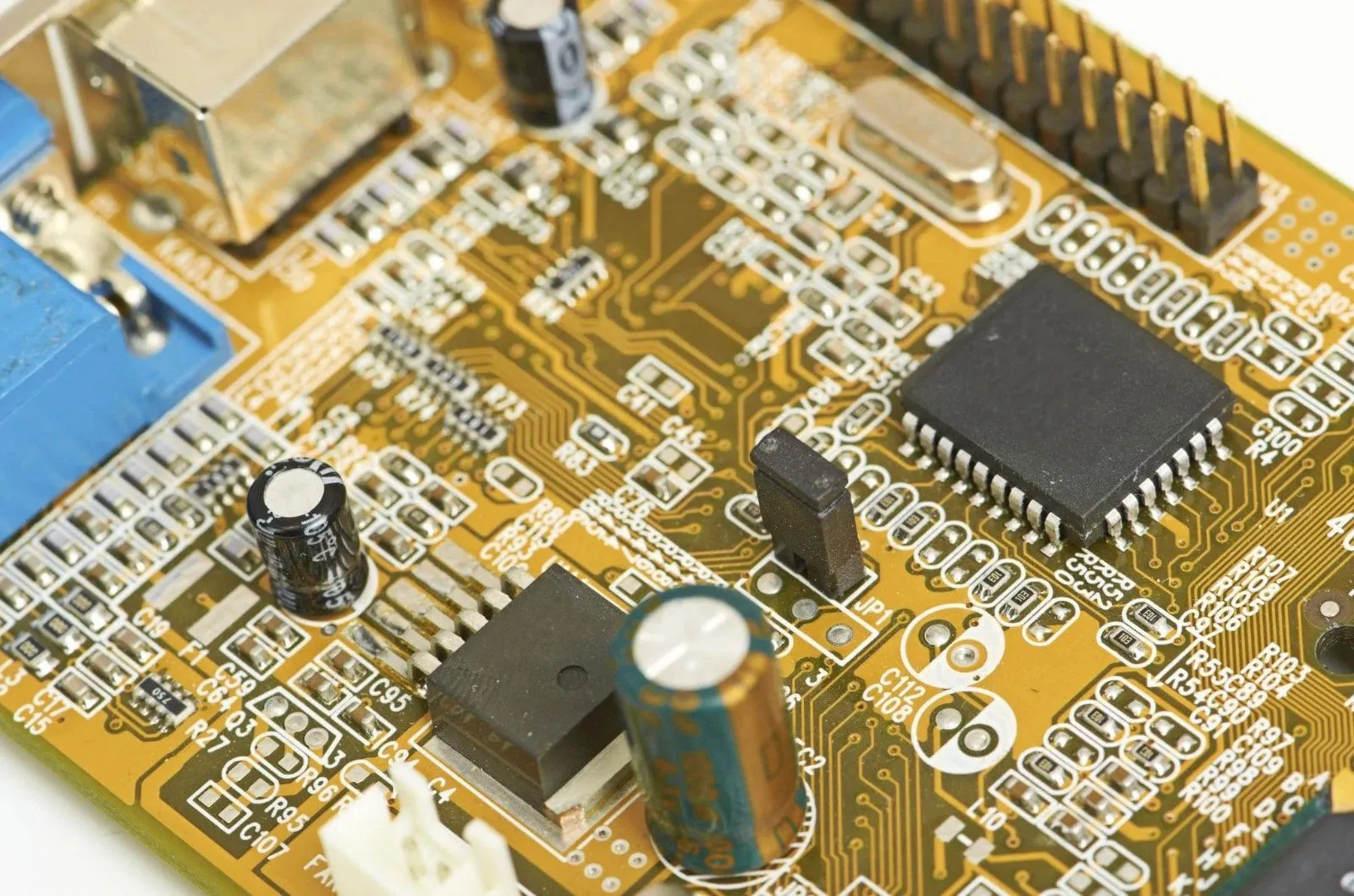 Close-up of a circuit board with a microcontroller, capacitors and connectors