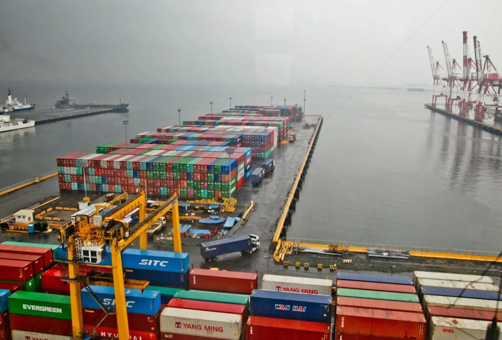 Container terminal with stacked shipping containers and cranes